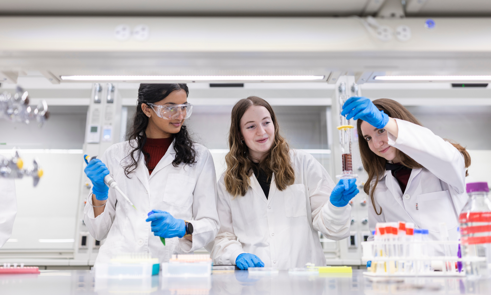 Three researchers work together in the SpinUp lab